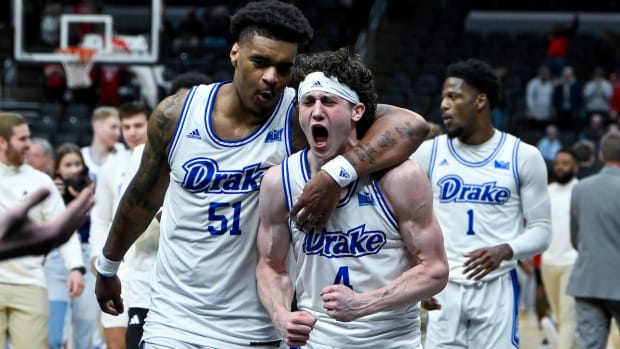 Drake Bulldogs guard Conor Enright (4) and forward Darnell Brodie (51) celebrate after the Bulldogs defeated the Bradley Braves in the Missouri Valley Conference Tournament semifinal game at Enterprise Center in St. Louis on March 9, 2024.